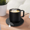 Chauffe-tasse électrique Cozya avec mug noir sur le bureau